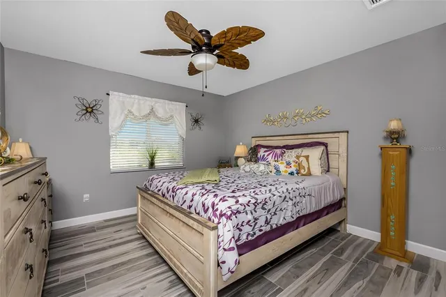 a bedroom with a large bed and a chandelier