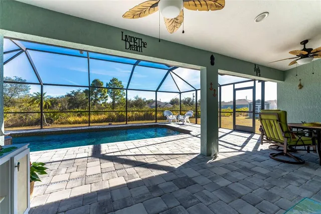 a view of a dining room with furniture and a floor to ceiling window
