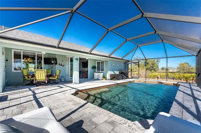 a view of a house with backyard porch and sitting area