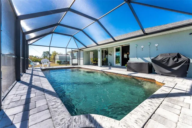 a view of swimming pool with seating space