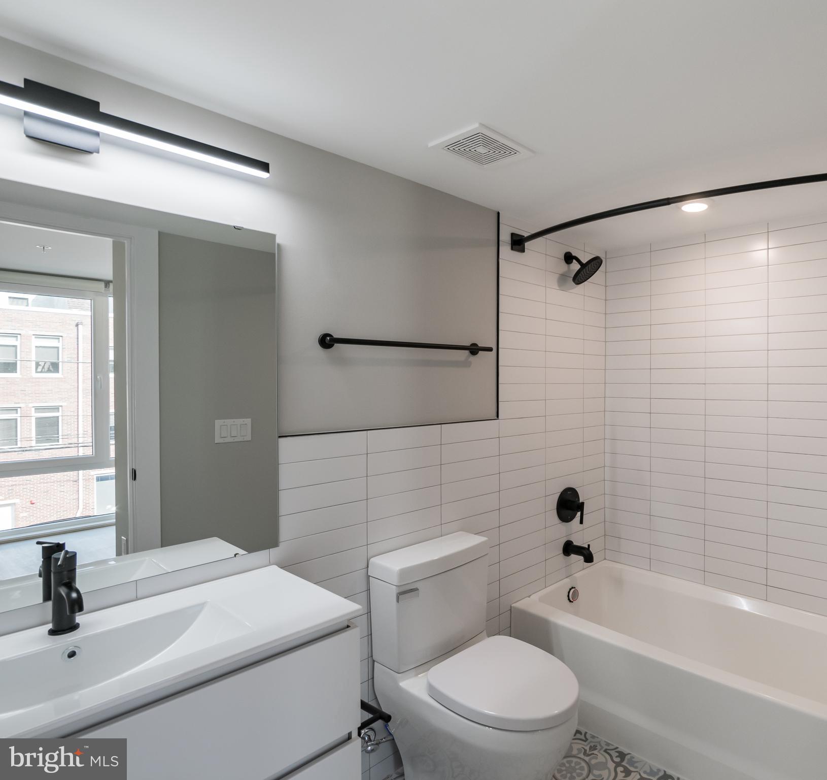 6604 Ridge Avenue, Unit 309 Philadelphia, PA 19128 - Photo 13 of 13 a bathroom with a sink a toilet and shower