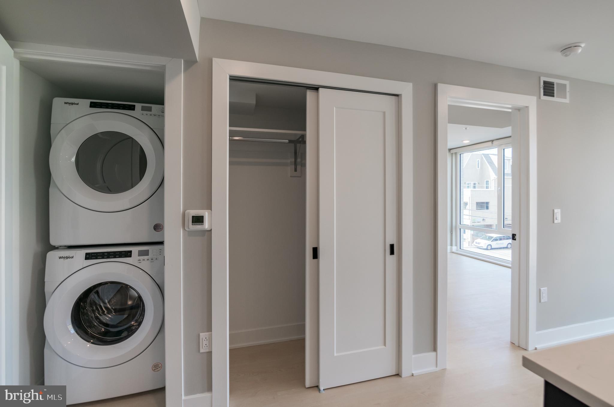 6604 Ridge Avenue, Unit 309 Philadelphia, PA 19128 - Photo 4 of 13 a view of a hallway with washer and dryer