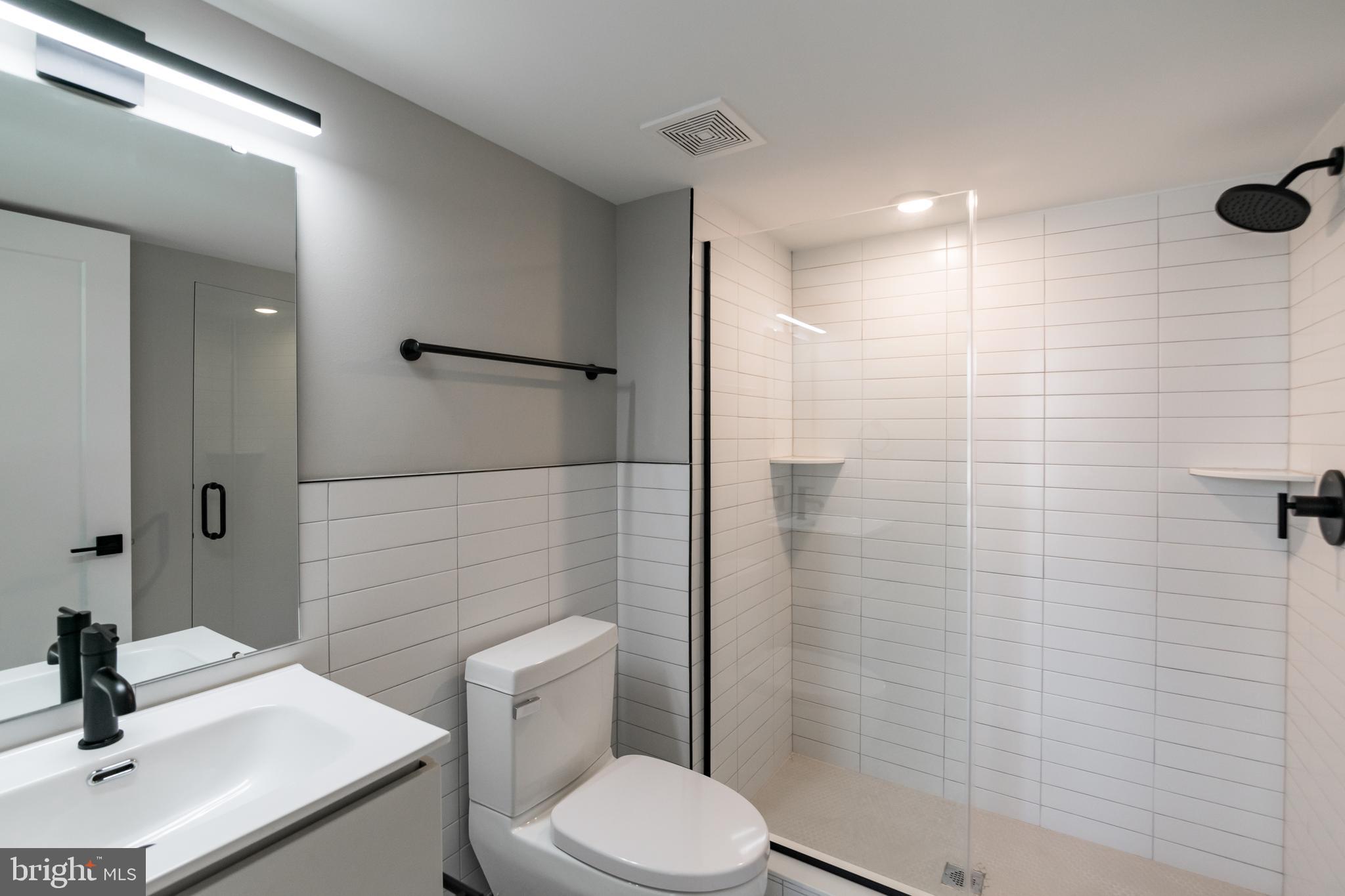 6604 Ridge Avenue, Unit 309 Philadelphia, PA 19128 - Photo 9 of 13 a bathroom with a sink a toilet and shower