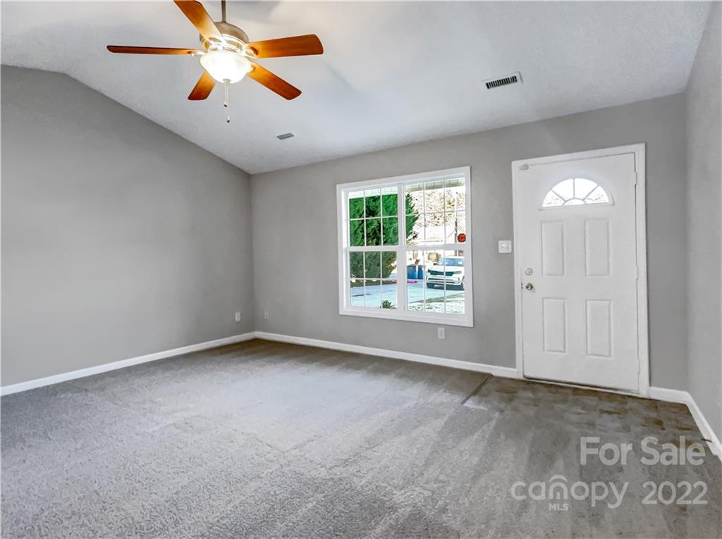 312 Springhill Lane Maiden, NC 28650 - Photo 4 of 18 an empty room with windows and chandelier fan
