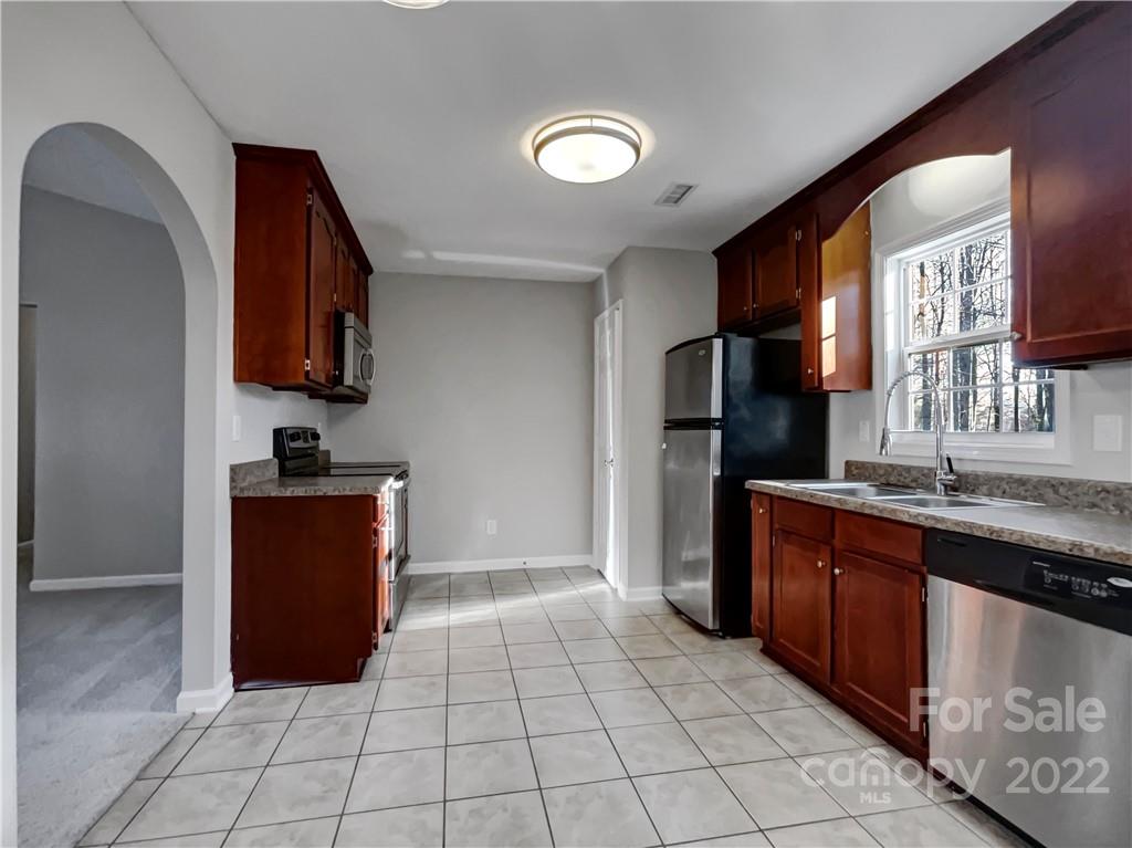 312 Springhill Lane Maiden, NC 28650 - Photo 5 of 18 a kitchen with stainless steel appliances granite countertop a refrigerator and a stove top oven