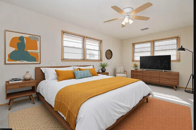 a bedroom with a bed and a flat screen tv