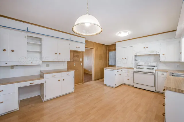 a kitchen with cabinets stainless steel appliances and a counter space