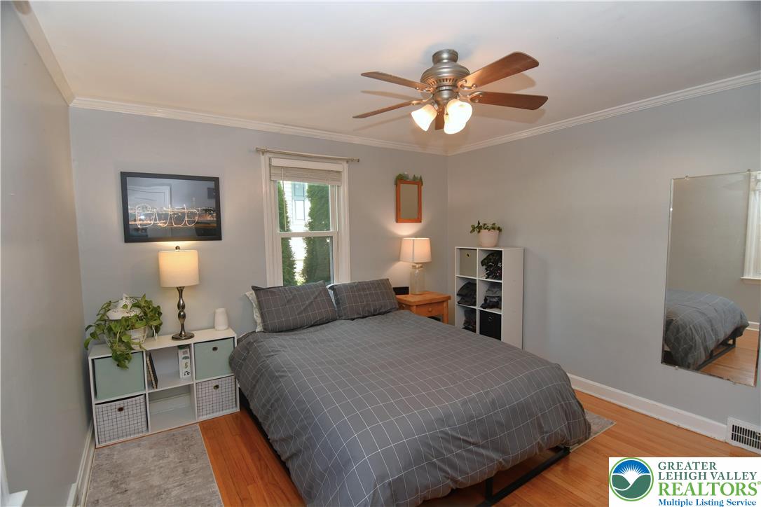 915 Birch Road Hellertown, PA 18055 - Photo 11 of 32 a bedroom with a bed and a chandelier