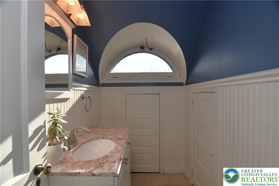 915 Birch Road Hellertown, PA 18055 - Photo 17 of 32 a bathroom with a sink and a mirror