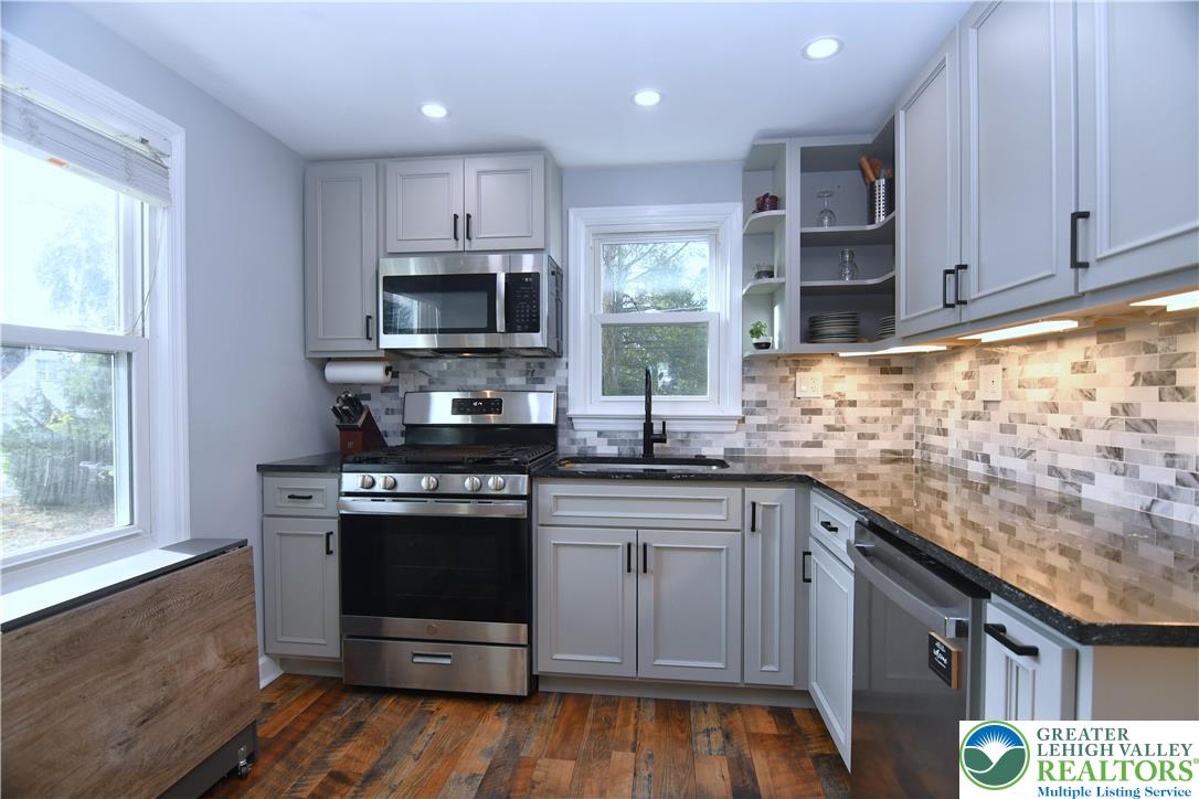915 Birch Road Hellertown, PA 18055 - Photo 6 of 32 a kitchen with stainless steel appliances granite countertop a stove a sink and a microwave
