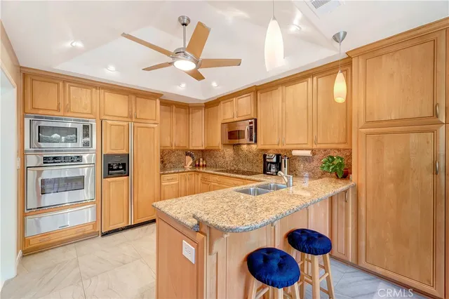 a view of a dining room and livingroom with furniture wooden floor a chandelier