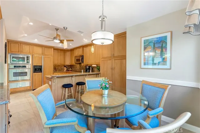 a dining room with furniture a chandelier and wooden floor