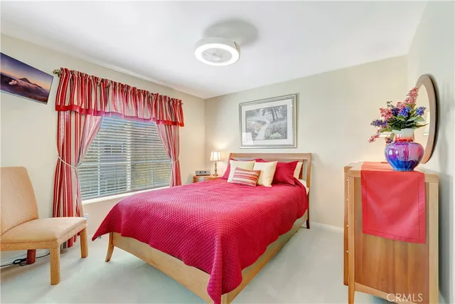 a front view of a house with a yard and potted plants