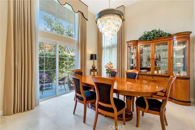 a view of a dining room with furniture water view and large windows