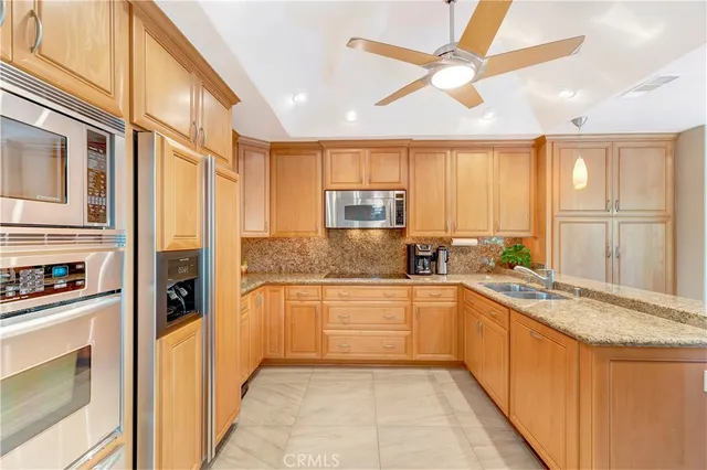 a kitchen with stainless steel appliances granite countertop a sink and cabinets