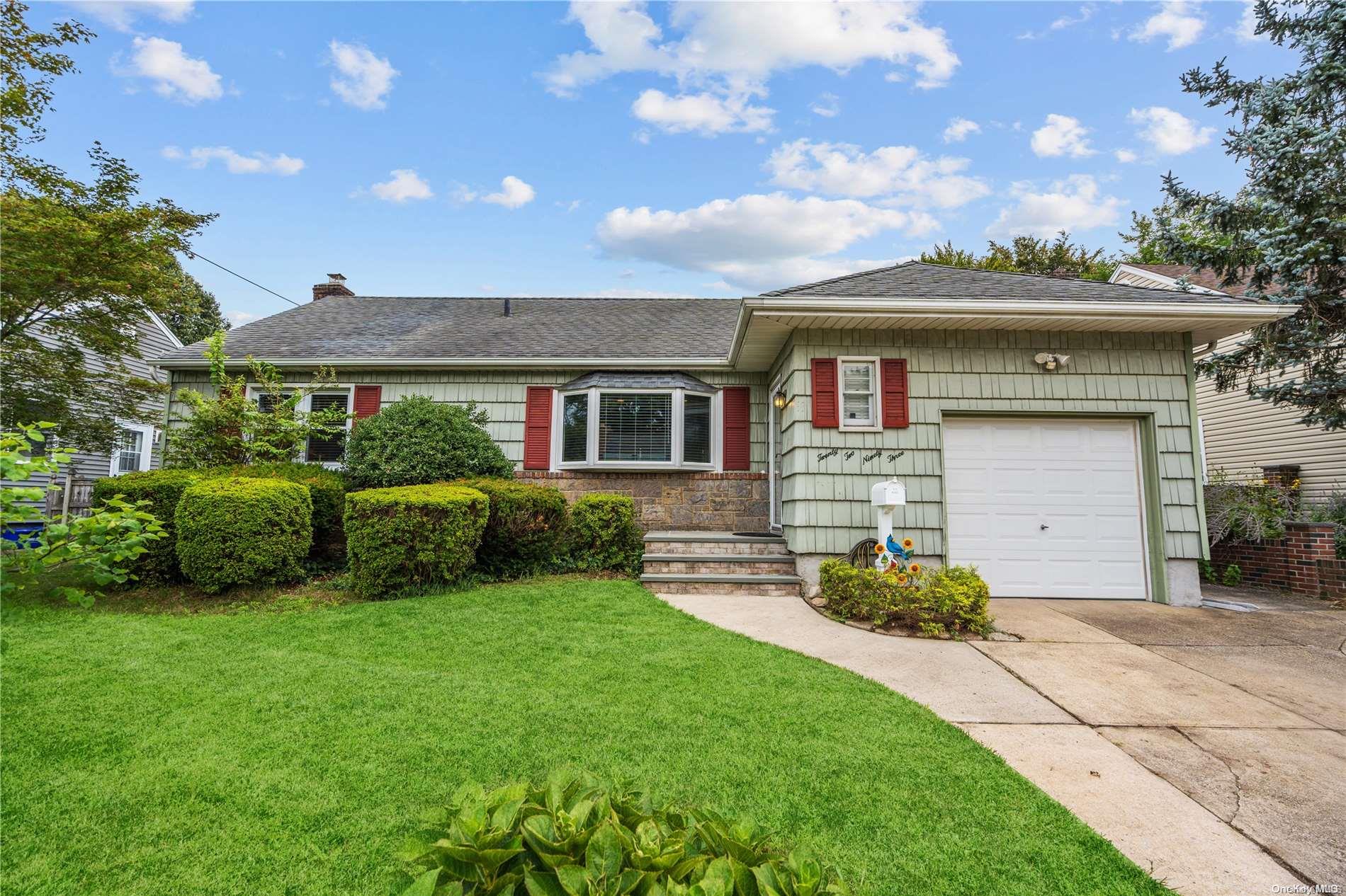 2293 Charing Cross Road Baldwin, NY 11510 - Photo 1 of 1 a front view of a house with a garden