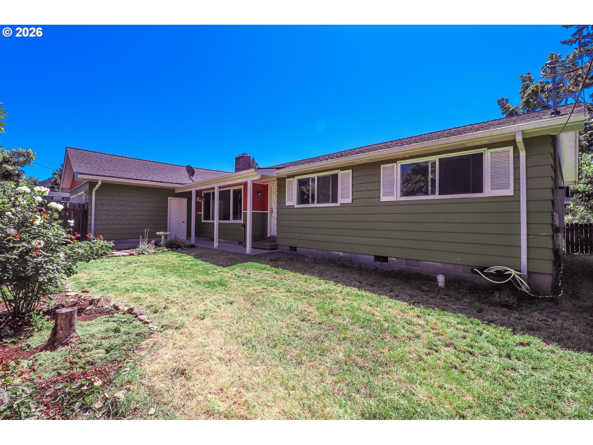7077 Main Street Springfield, OR 97478 - Photo 2 of 34 a front view of a house with garden