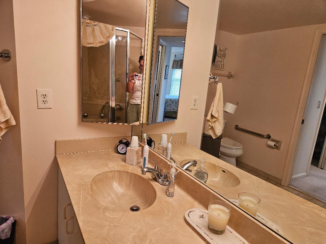 6070 Southeast Martinique Drive, Unit 103 Stuart, FL 34997 - Photo 15 of 30 a bathroom with a sink and a mirror