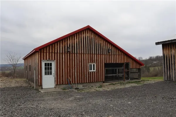 a view of a house with wooden fence