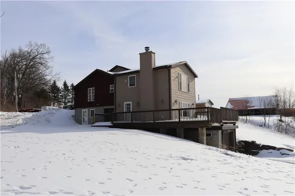 a view of a house with a snow in the yard