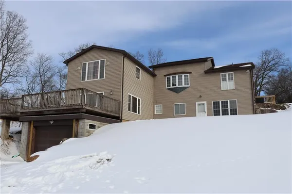 a view of a house with wooden fence