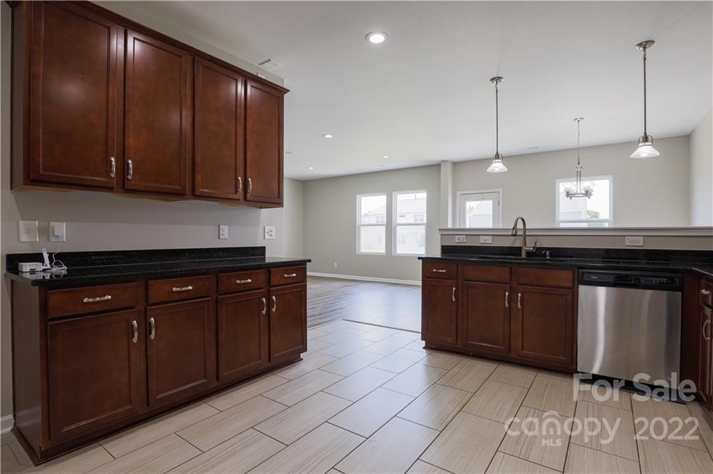 12507 Bending Branch Road Charlotte, NC 28227 - Photo 12 of 23 a kitchen with stainless steel appliances granite countertop a sink a stove and a wooden cabinets