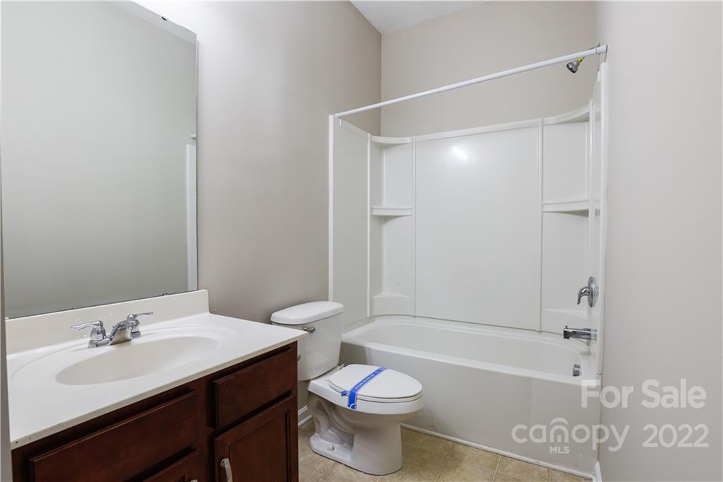 12507 Bending Branch Road Charlotte, NC 28227 - Photo 13 of 23 a bathroom with a sink toilet vanity and shower
