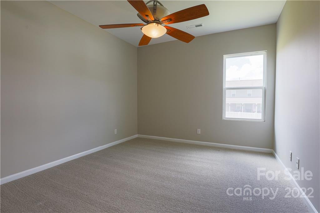 12507 Bending Branch Road Charlotte, NC 28227 - Photo 14 of 23 an empty room with a window and a fan