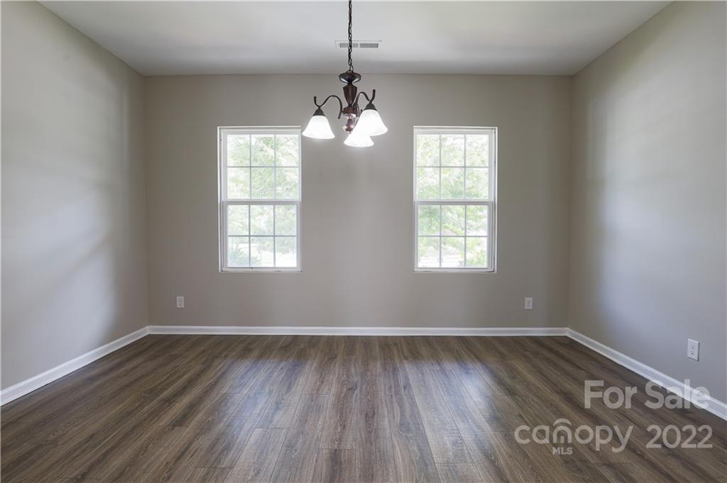 12507 Bending Branch Road Charlotte, NC 28227 - Photo 16 of 23 a room with wooden floor and windows