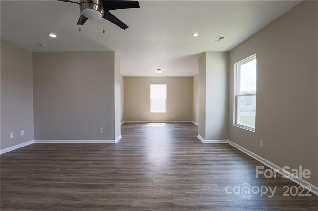 12507 Bending Branch Road Charlotte, NC 28227 - Photo 17 of 23 a view of empty room with wooden floor and fan