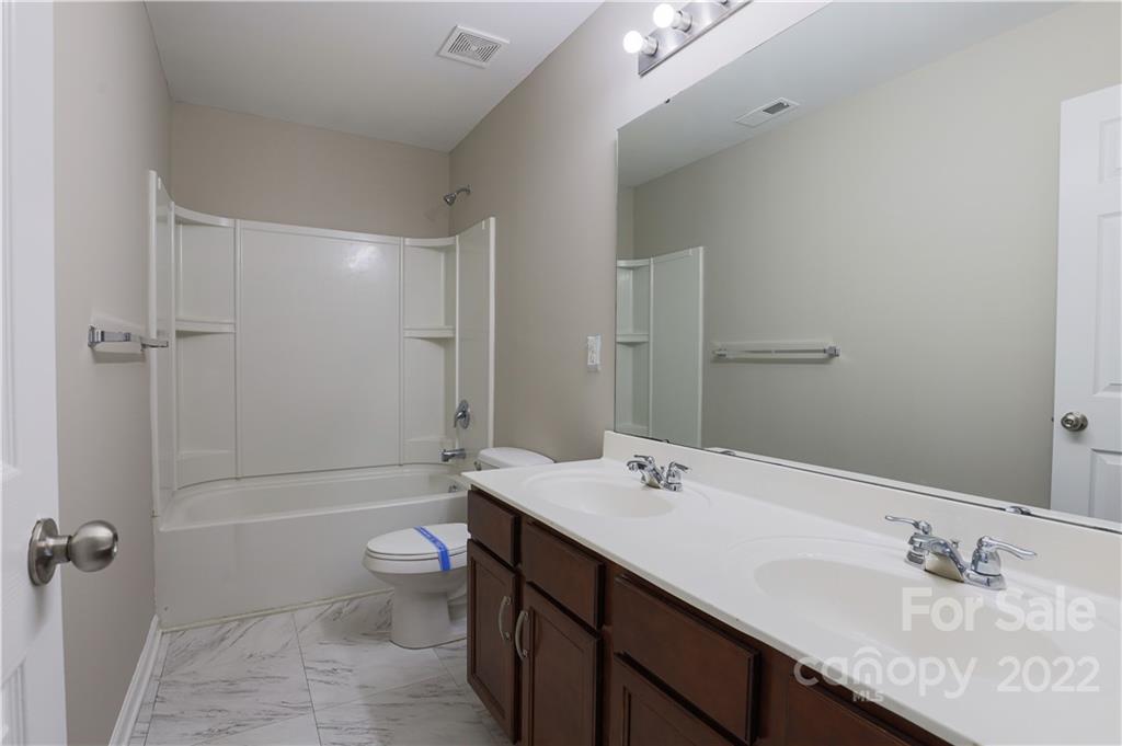 12507 Bending Branch Road Charlotte, NC 28227 - Photo 18 of 23 a bathroom with a granite countertop sink a toilet and shower