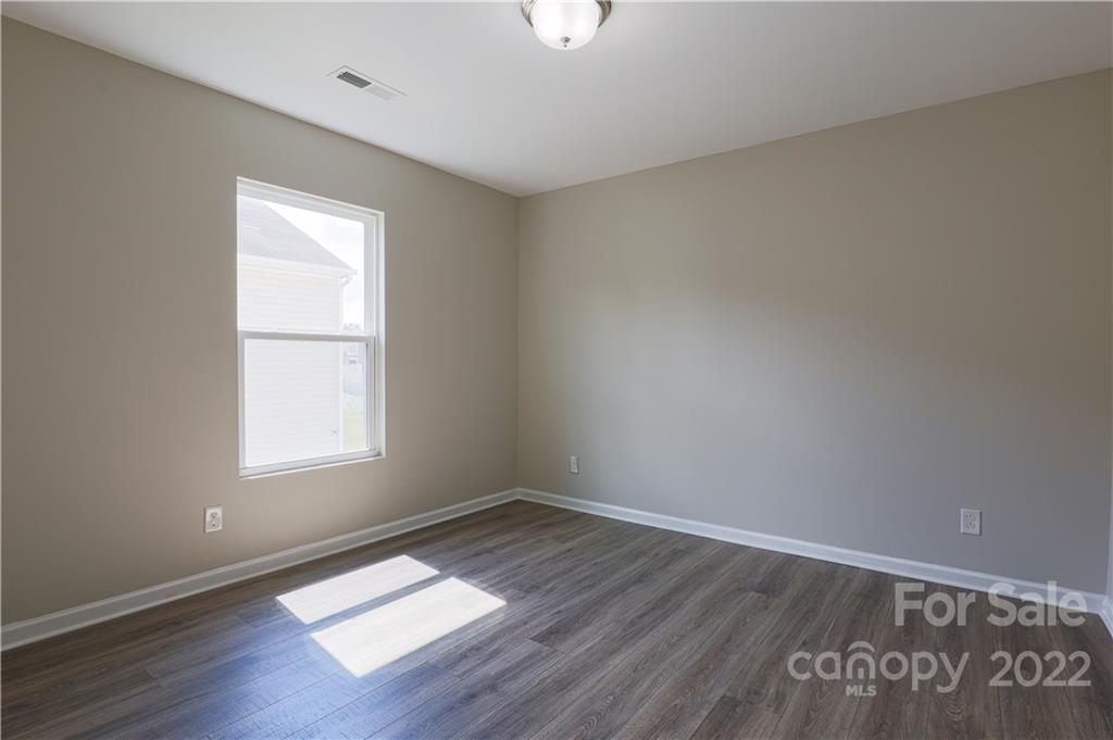 12507 Bending Branch Road Charlotte, NC 28227 - Photo 20 of 23 an empty room with wooden floor and windows