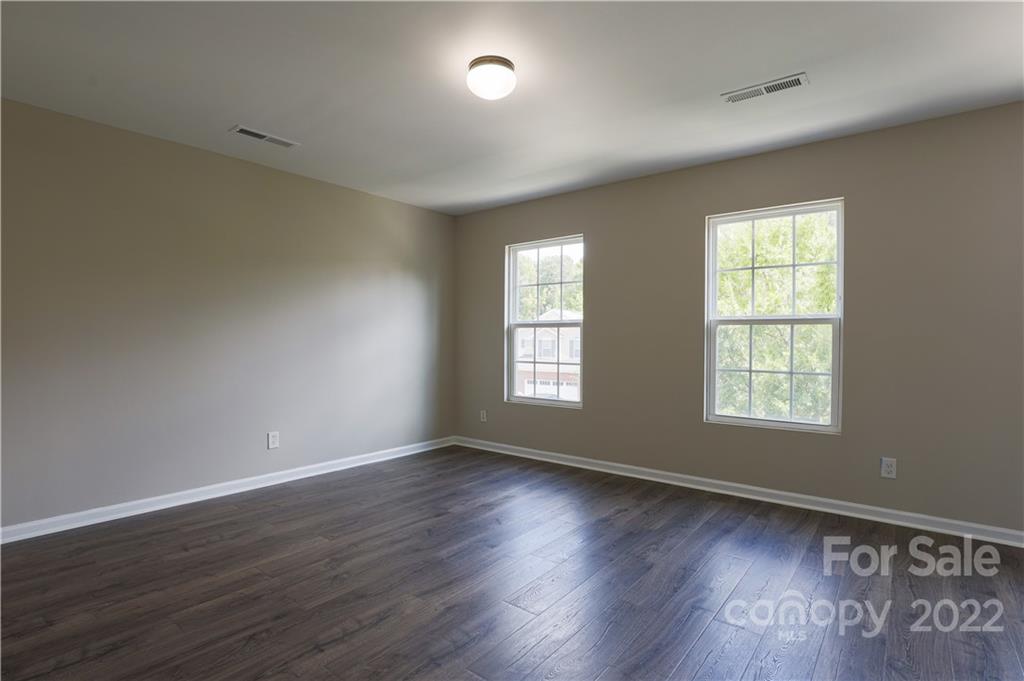12507 Bending Branch Road Charlotte, NC 28227 - Photo 21 of 23 a view of an empty room with wooden floor and a window