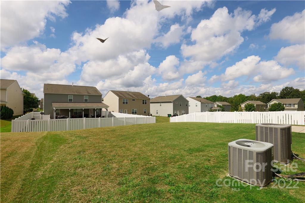 12507 Bending Branch Road Charlotte, NC 28227 - Photo 23 of 23 a house view with swimming pool and trees in the background