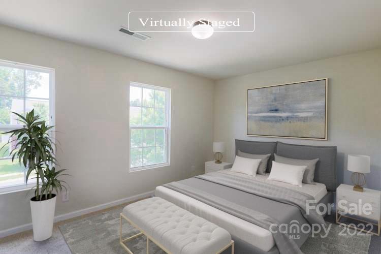 12507 Bending Branch Road Charlotte, NC 28227 - Photo 4 of 23 a bedroom with a bed and a potted plant