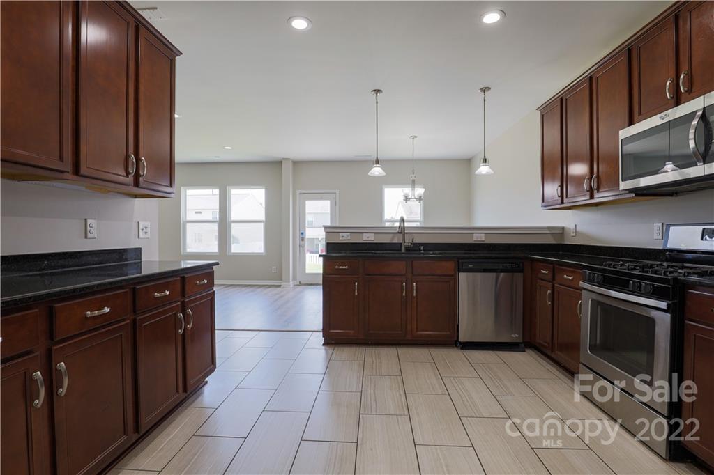12507 Bending Branch Road Charlotte, NC 28227 - Photo 6 of 23 a kitchen with a sink a stove and cabinets