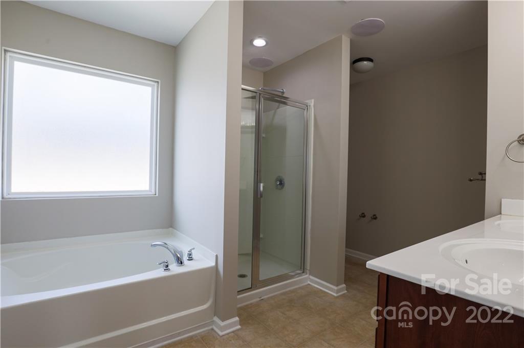 12507 Bending Branch Road Charlotte, NC 28227 - Photo 7 of 23 a bathroom with a tub a sink and a shower