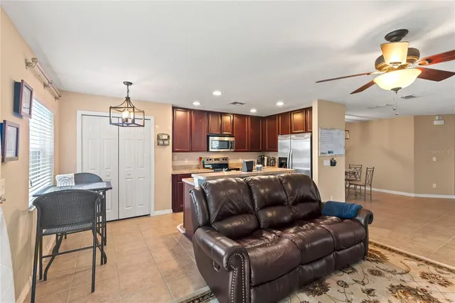a living room with furniture and a chandelier