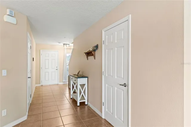 a view of a hallway with closet and front door