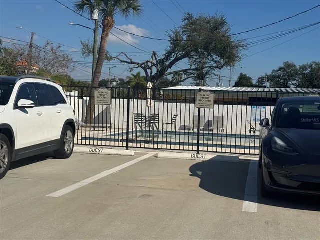 a view of a street with lots of trees and plants