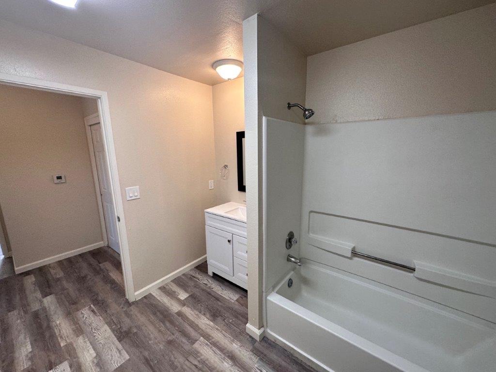 1405 East Cypress Avenue Reedley, CA 93654 - Photo 28 of 29 a bathroom with a bathtub and shower