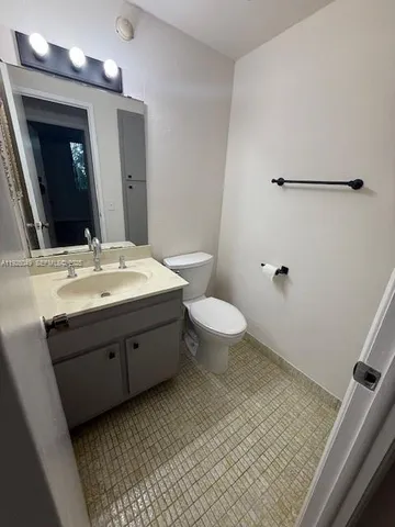 a bathroom with a sink toilet and mirror