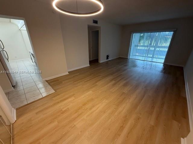4200 Hillcrest Drive, Unit 206 Hollywood, FL 33021 - Photo 2 of 15 a view of an empty room with wooden floor and a window