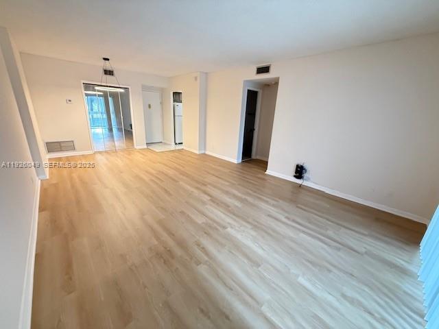 4200 Hillcrest Drive, Unit 206 Hollywood, FL 33021 - Photo 4 of 15 a view of an empty room with wooden floor and a window