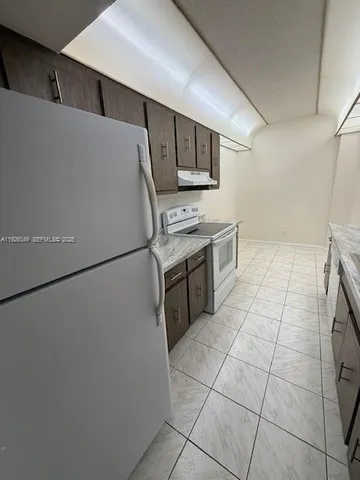 a kitchen with stainless steel appliances a refrigerator sink and microwave
