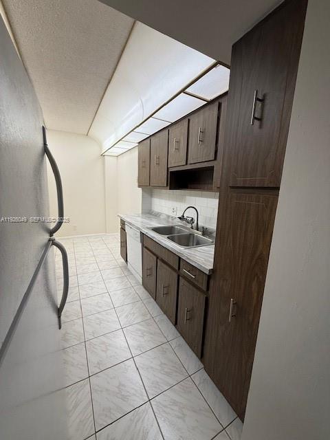 4200 Hillcrest Drive, Unit 206 Hollywood, FL 33021 - Photo 9 of 15 a kitchen with a sink a stove and a refrigerator