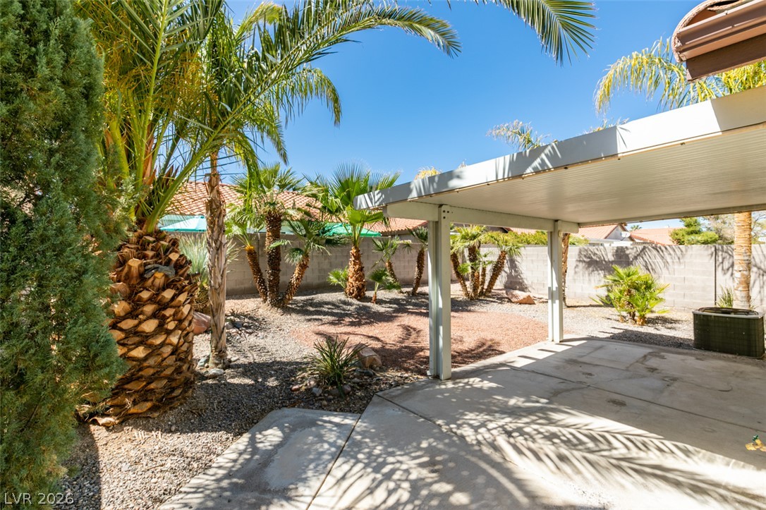 307 Cavalla Street Henderson, NV 89074 - Photo 39 of 44 Lush landscaping and a covered patio create an inviting outdoor retreat.