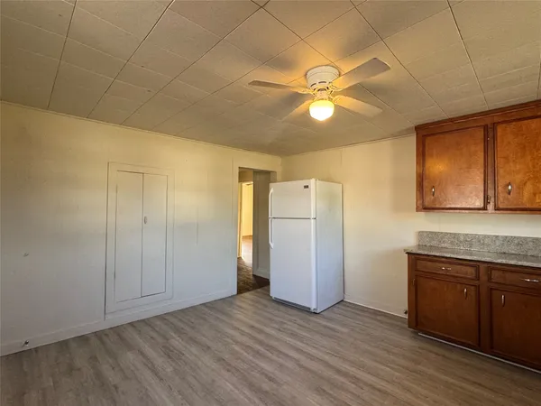 a view of a kitchen with a sink and a refrigerator
