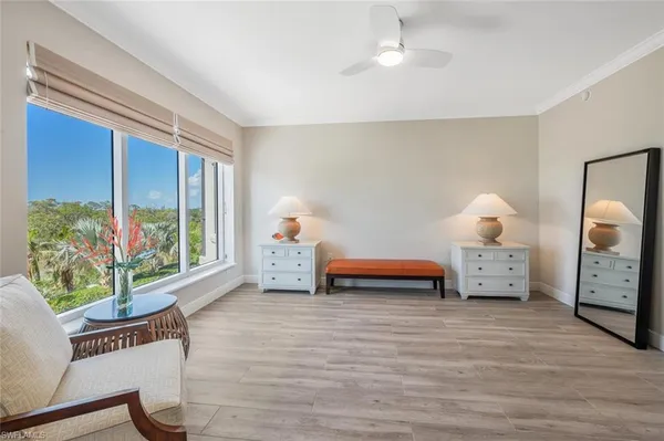 a bedroom with furniture and a window