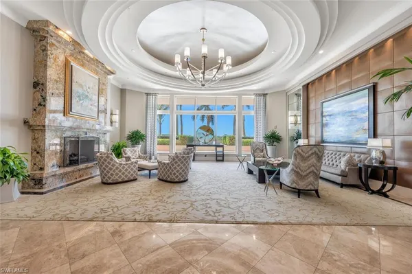 a living room with furniture and a chandelier